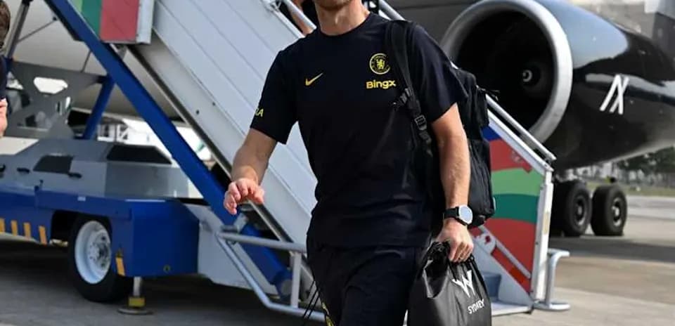Coach walking down airplane steps at airport