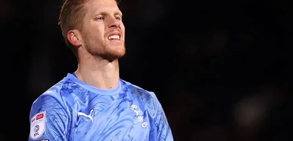 Goalkeeper wearing blue kit during match