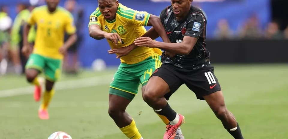 Players battling for possession during soccer match