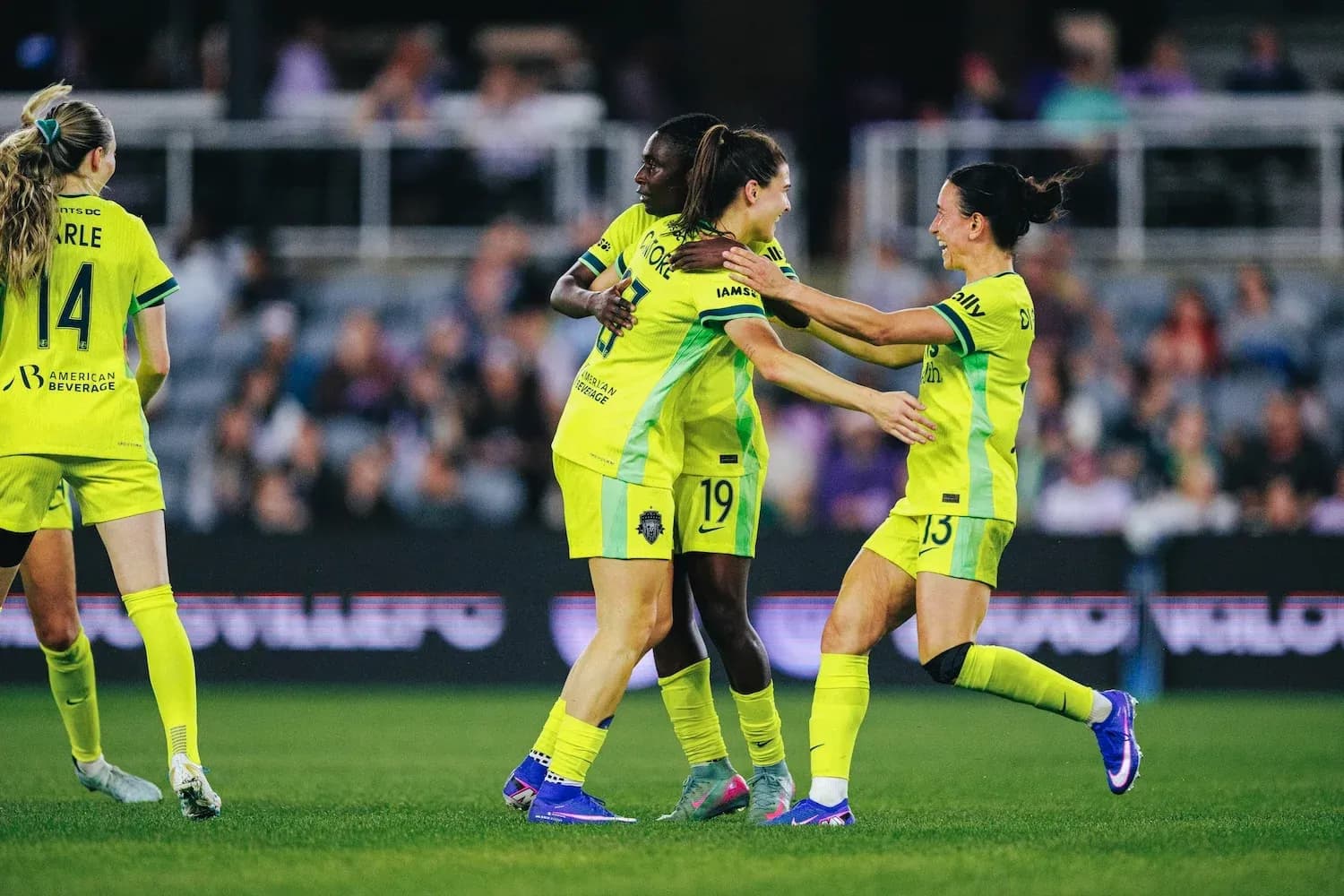 Players celebrating during NWSL match