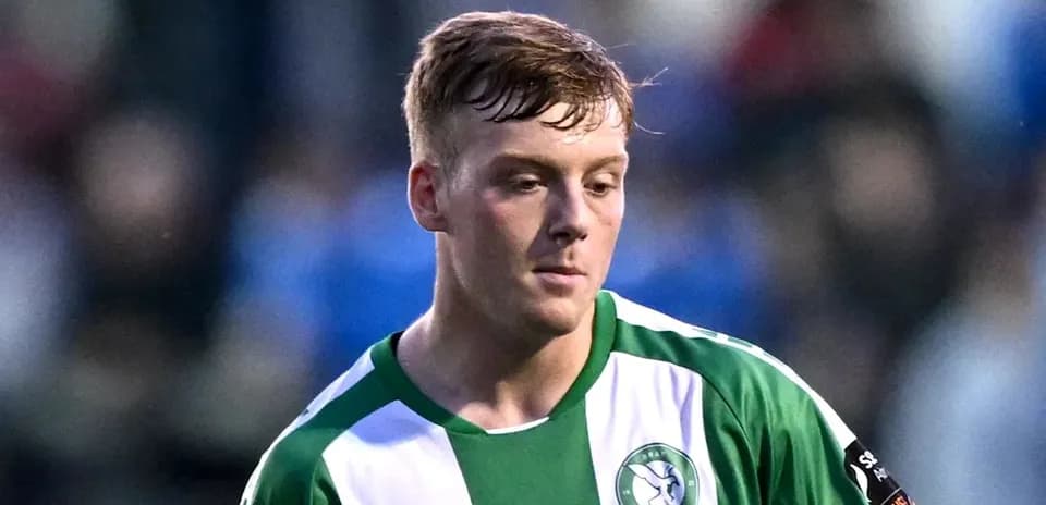 Player wearing green and white jersey during match