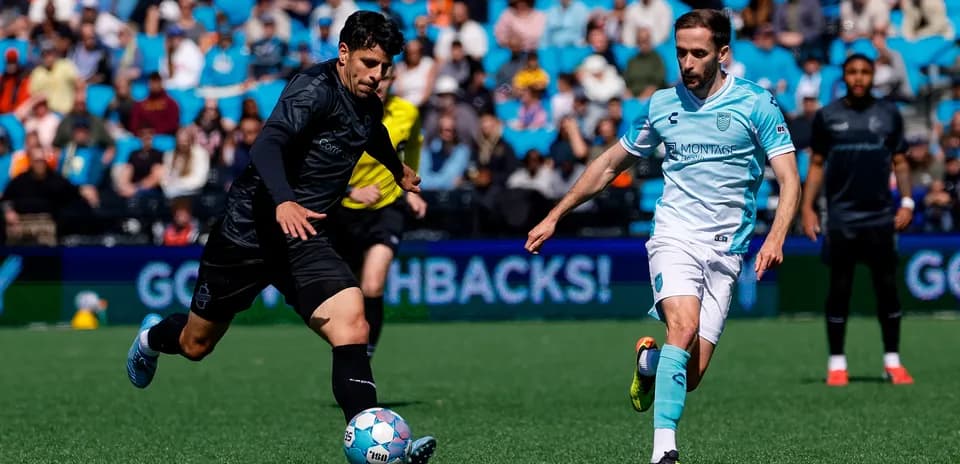 Player kicking ball during Monterey Bay match