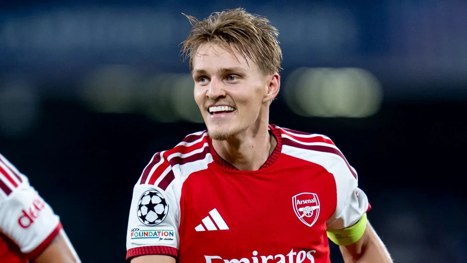 Player celebrating in Arsenal's red home kit