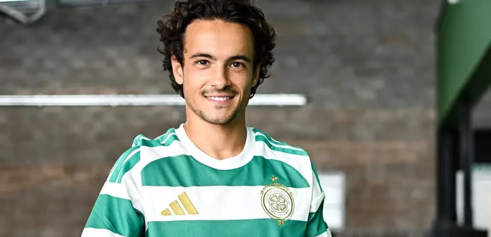 Player wearing green and white striped jersey smiling