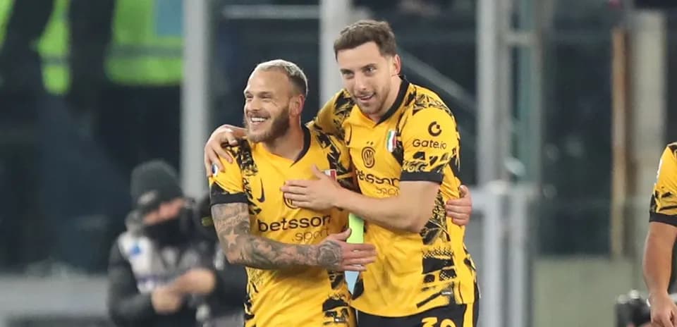 Two players celebrating a goal on the pitch