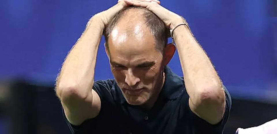 Coach with hands on head during match