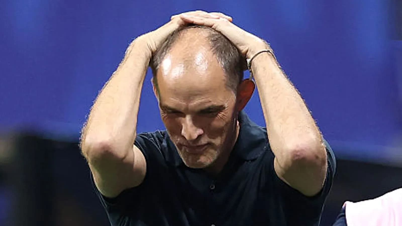 Coach with hands on head during match
