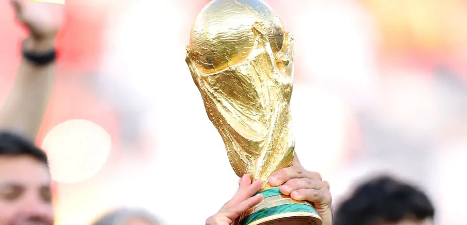 Golden FIFA World Cup trophy held aloft