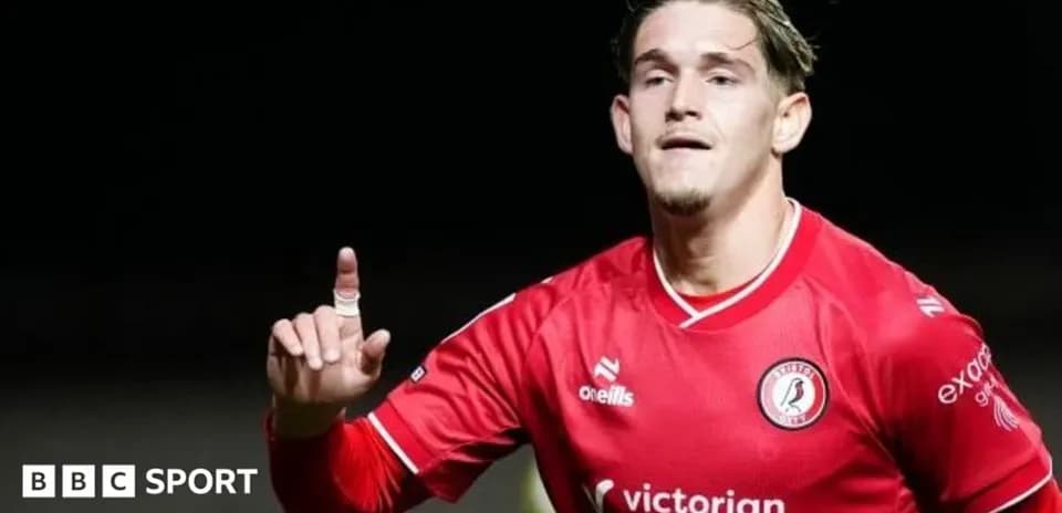 Player celebrating after scoring a goal in red jersey