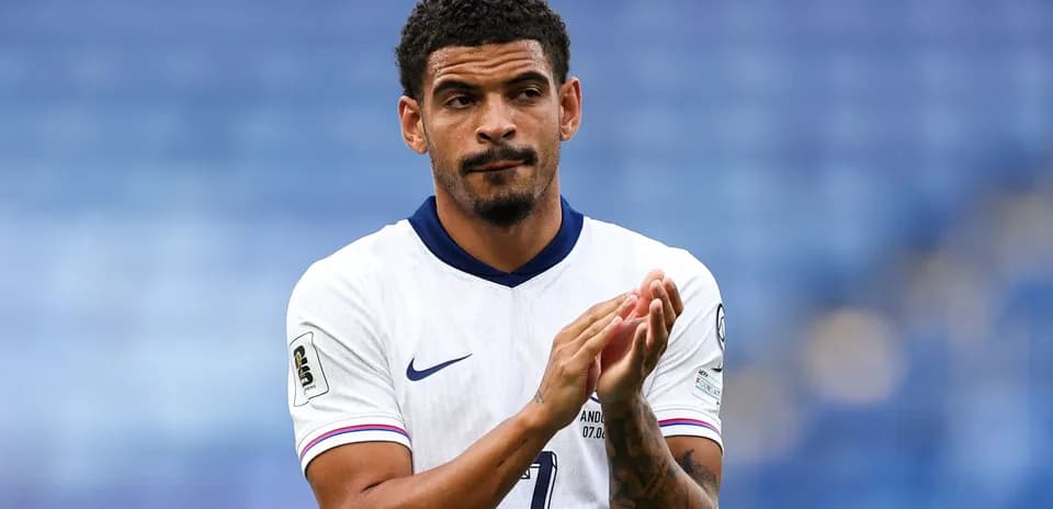 Player applauding in white jersey during match