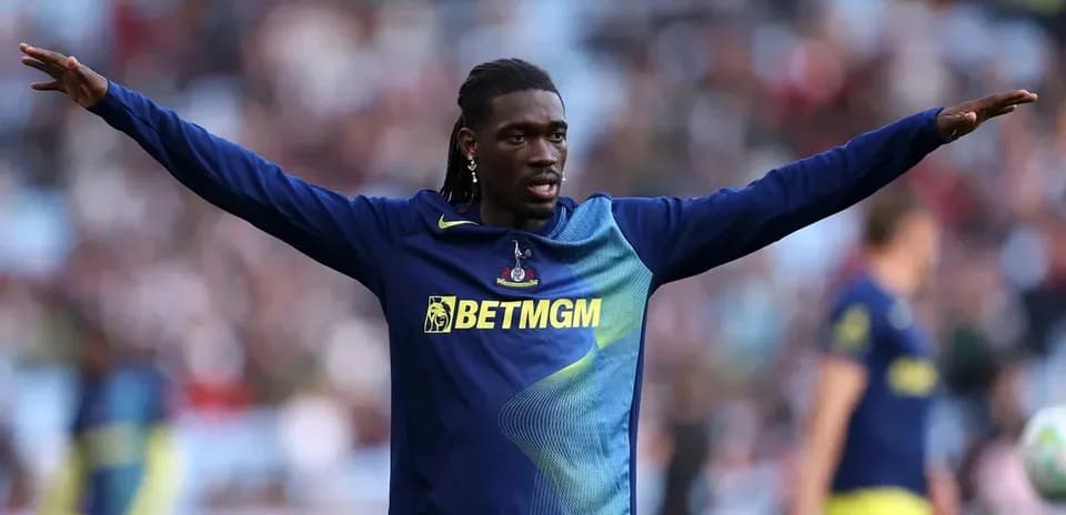 Player warming up with arms outstretched before match