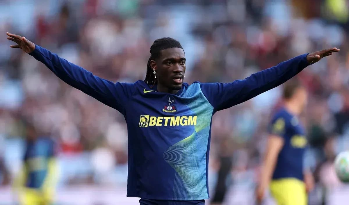 Player warming up with arms outstretched before match