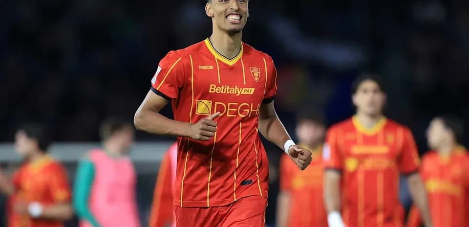 Player celebrating in red team jersey during match