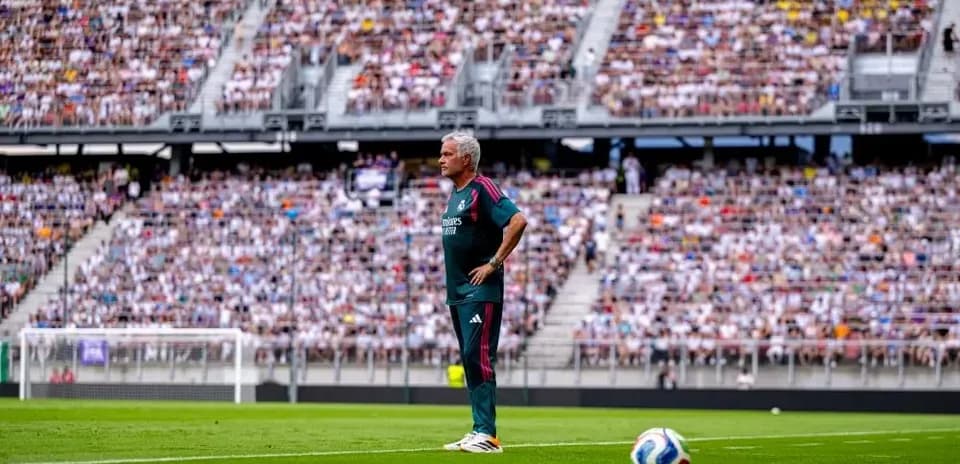 Coach observing match from the sidelines in stadium