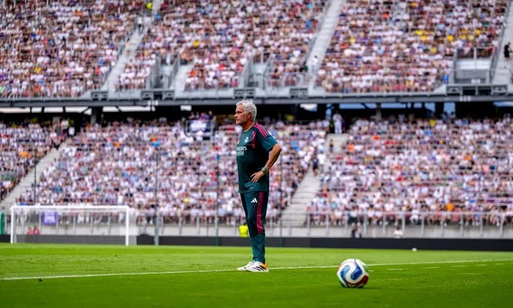 Coach observing match from the sidelines in stadium