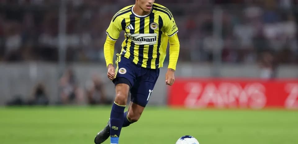 Fenerbahçe player dribbling ball on field