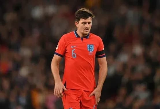Player in red England kit walking on the pitch