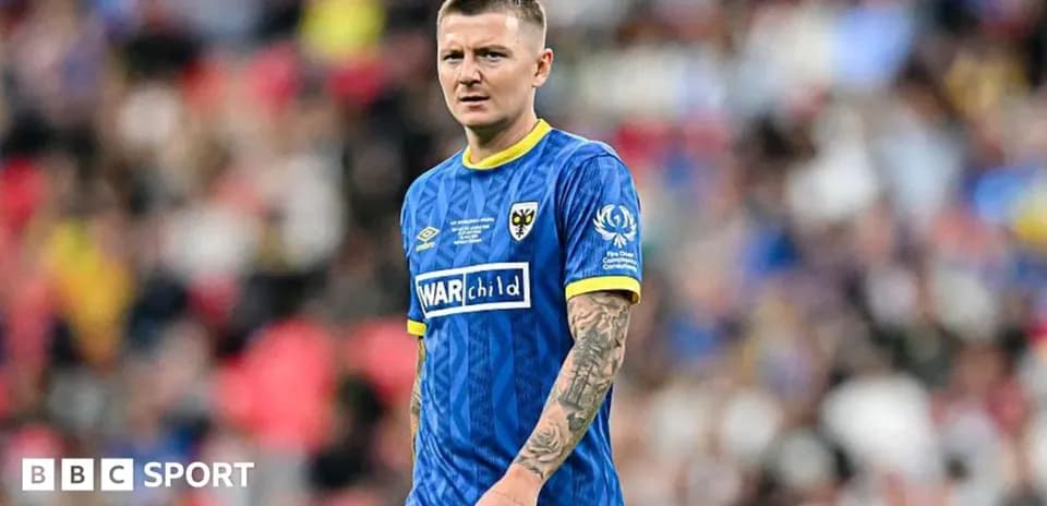 Player in blue kit during football match
