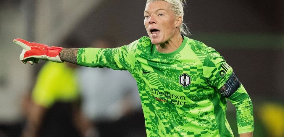 Goalkeeper directing play during women's football match