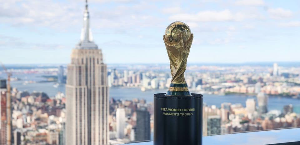 FIFA World Cup trophy with city skyline background