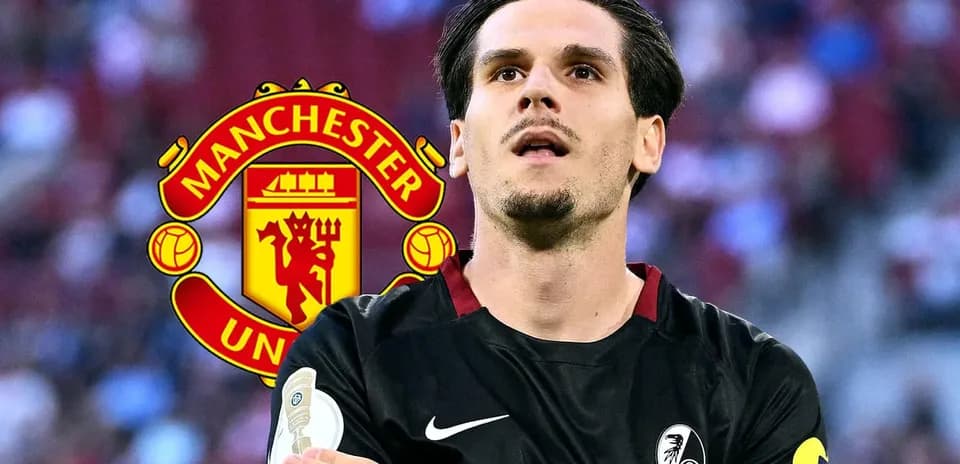 Player in black kit with Manchester United logo background