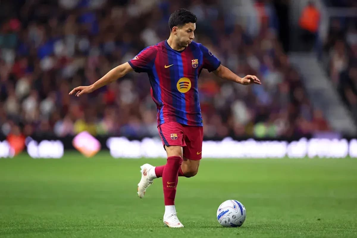 Barcelona player dribbling ball on field