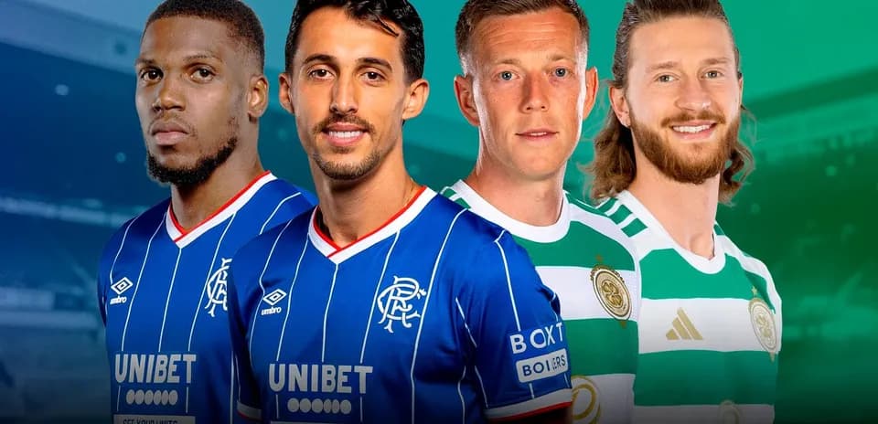 Four football players in team jerseys posing together