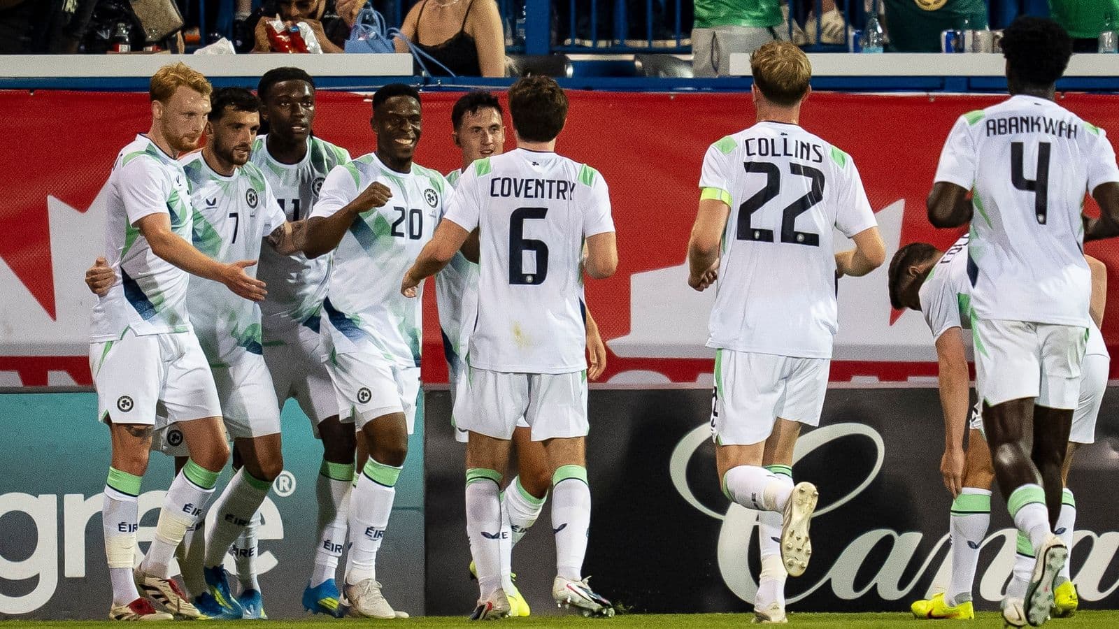 Players celebrating a goal during a soccer match