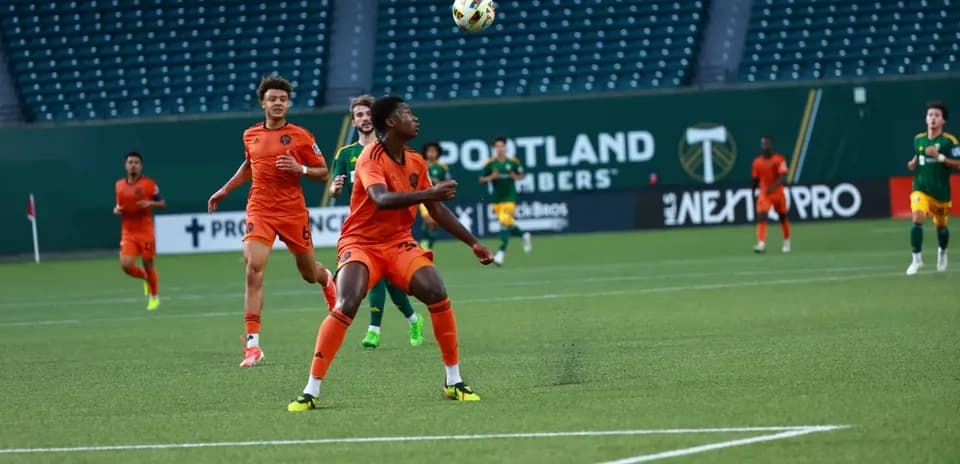 Players competing for the ball during match