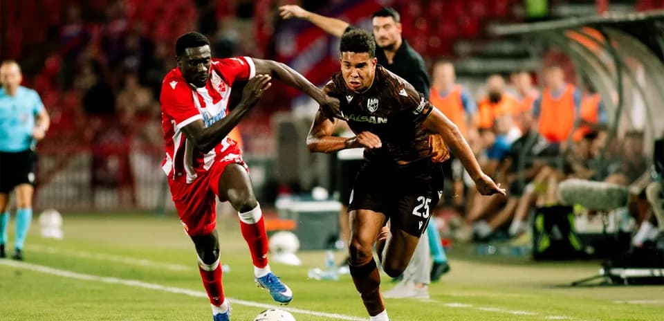 Players competing for the ball in UEFA match