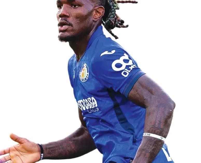 Player in blue jersey celebrating on the field