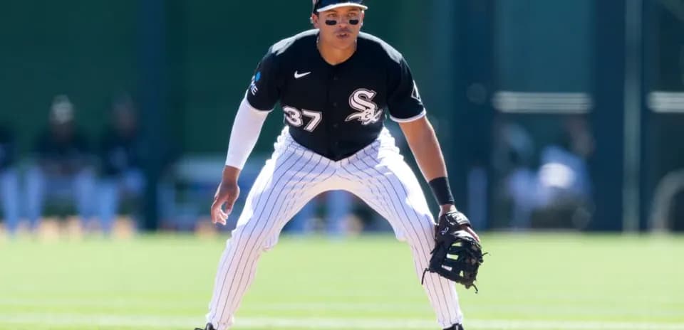 Baseball player in fielding position during game