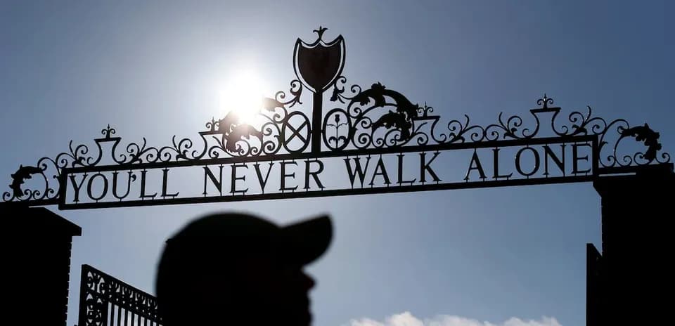Sign reading 'YOU'LL NEVER WALK ALONE' at stadium