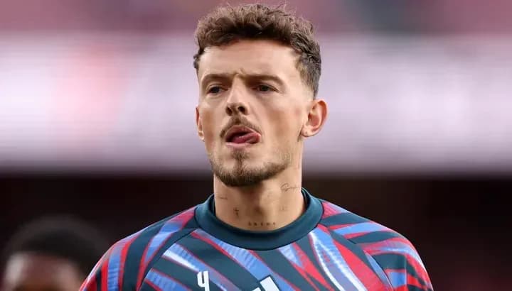 Goalkeeper wearing colorful kit during match warm-up