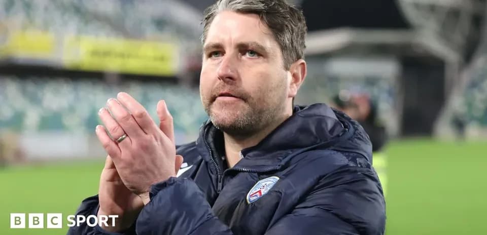 Coach applauding fans after match in stadium