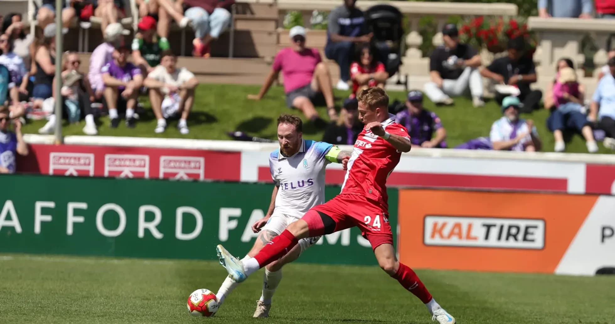 Pacific FC player challenges Cavalry FC opponent