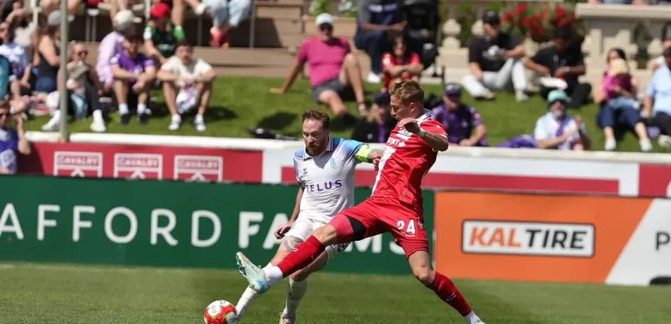 Pacific FC player challenges Cavalry FC opponent