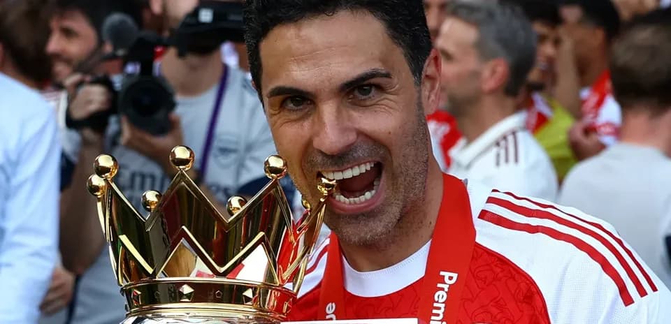 Manager celebrating with Premier League trophy