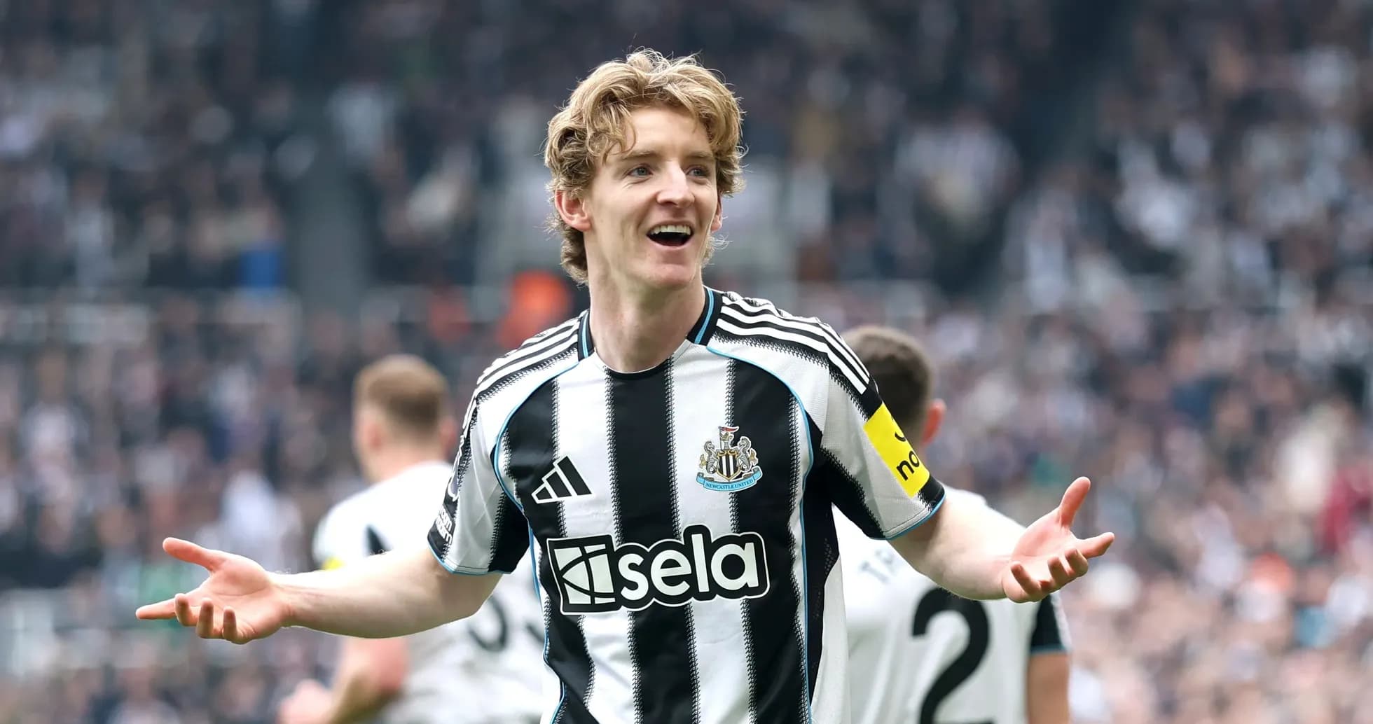 Newcastle player celebrating with fans during match