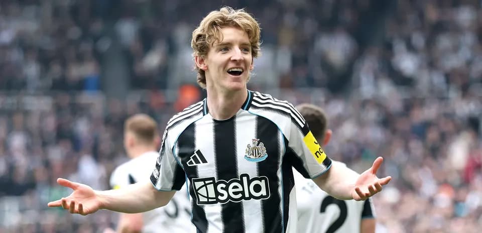 Newcastle player celebrating with fans during match