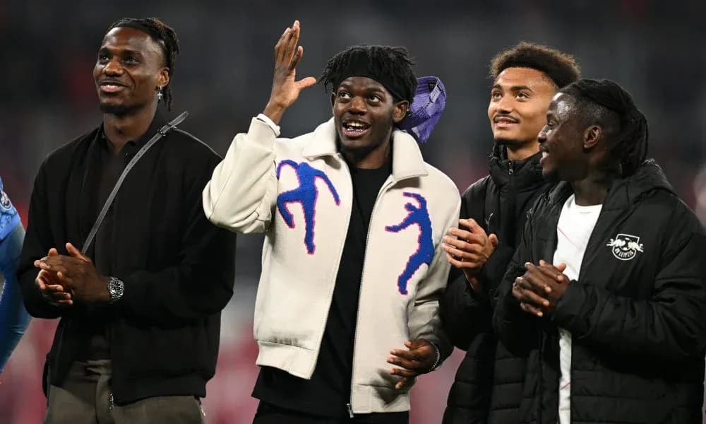 Four players celebrating together on the field