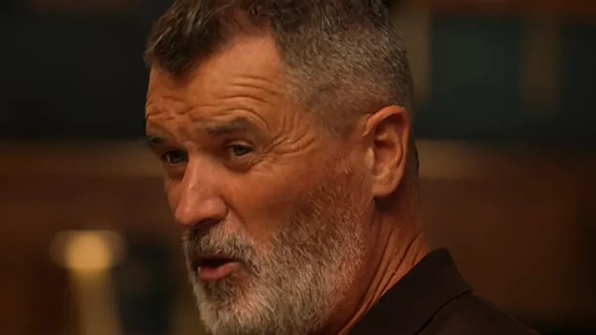 Man with gray beard speaking in a room