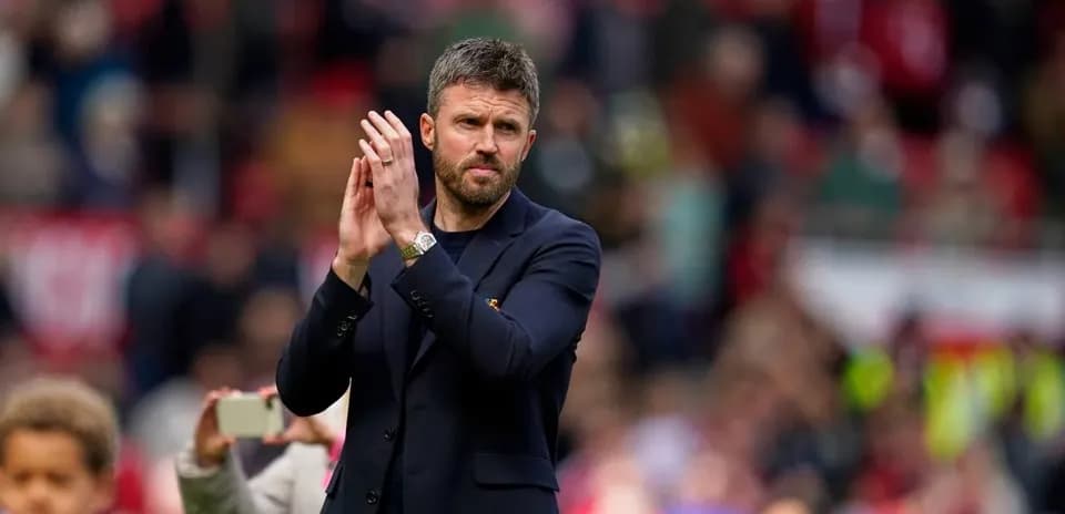 Coach applauding fans during post-match ceremony