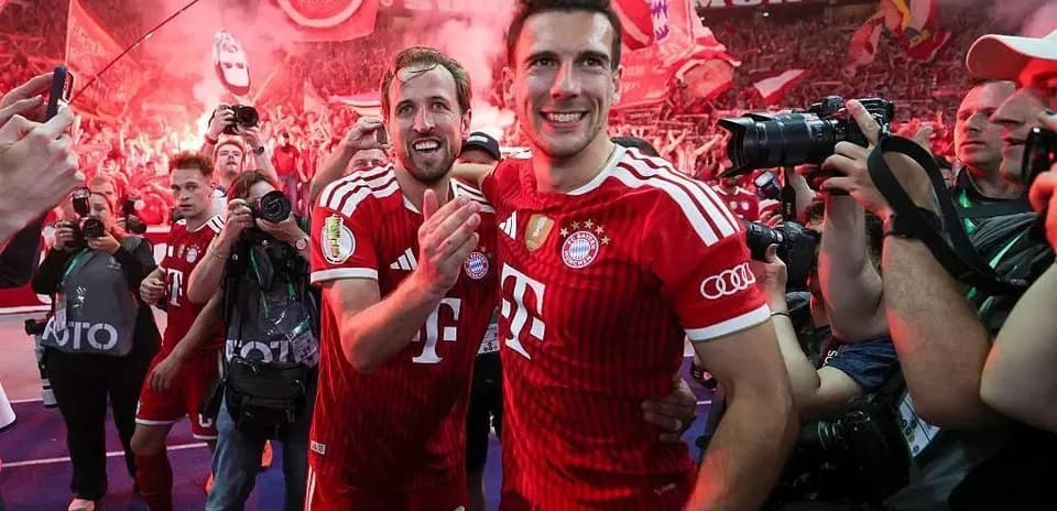 Bayern Munich players celebrating with fans in stadium