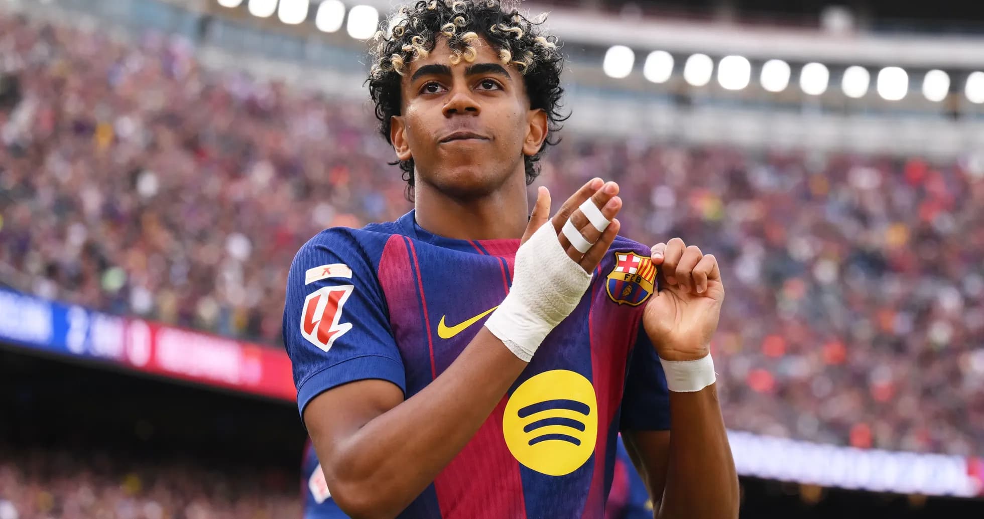 Player celebrating while holding club badge on shirt