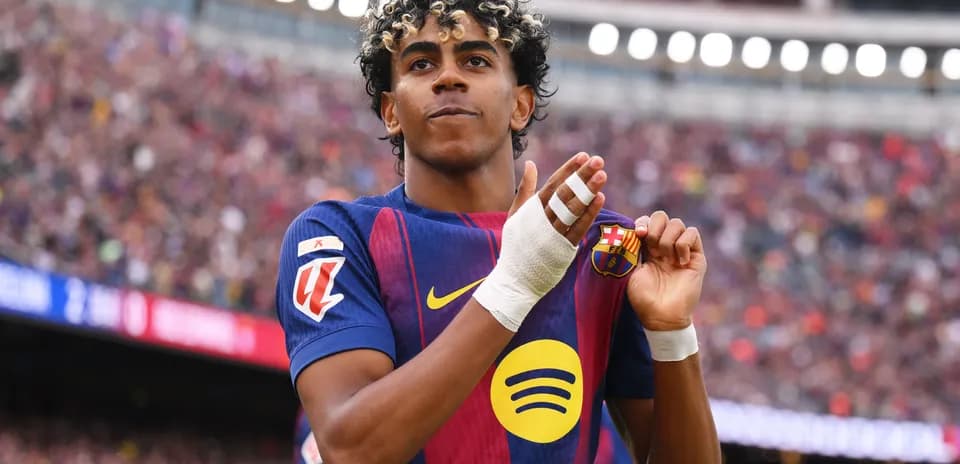 Player celebrating while holding club badge on shirt