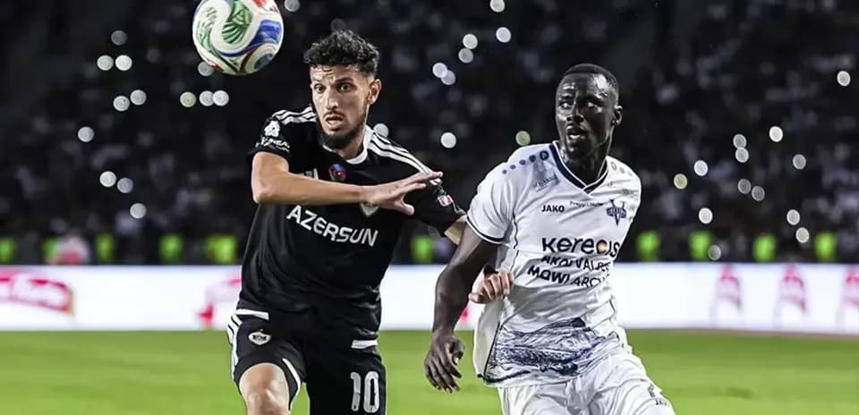 Players competing for the ball in UEFA match