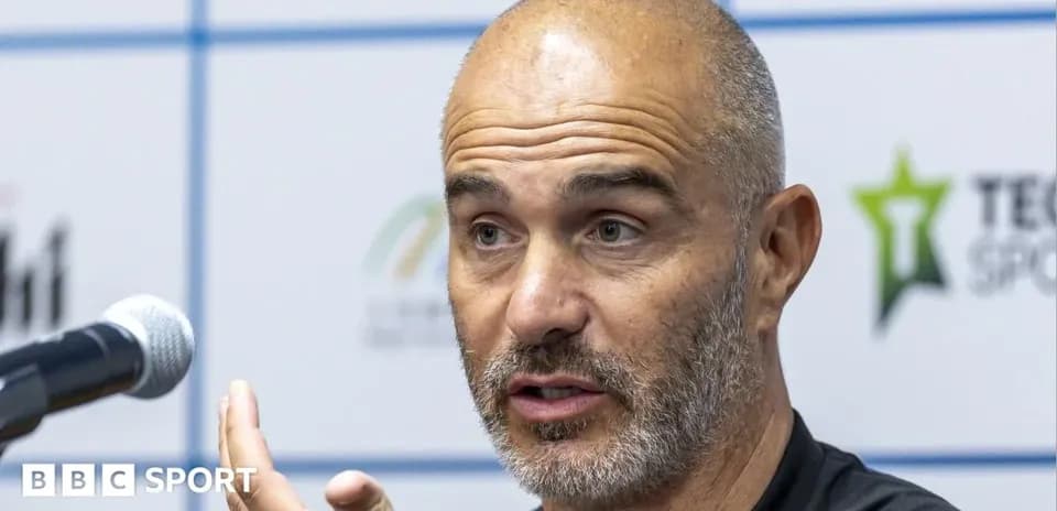 Manager speaking at press conference with microphone