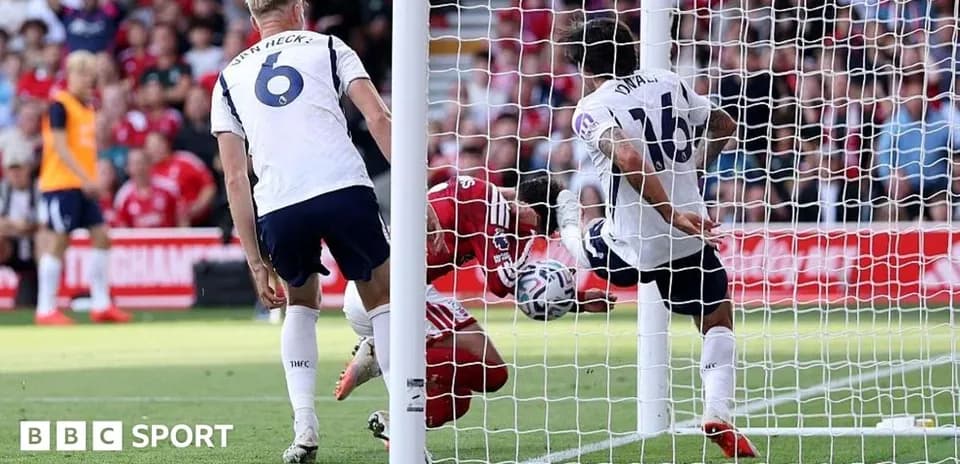 Goalkeeper diving to save shot near goal post
