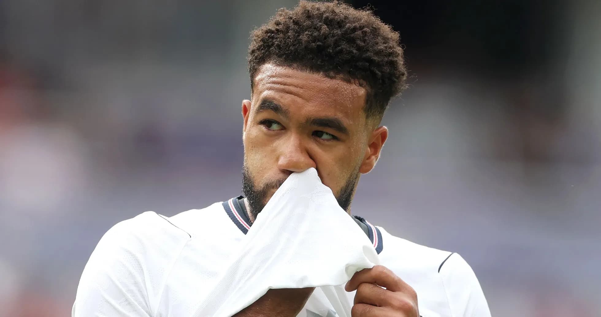 Player holding jersey to face during match